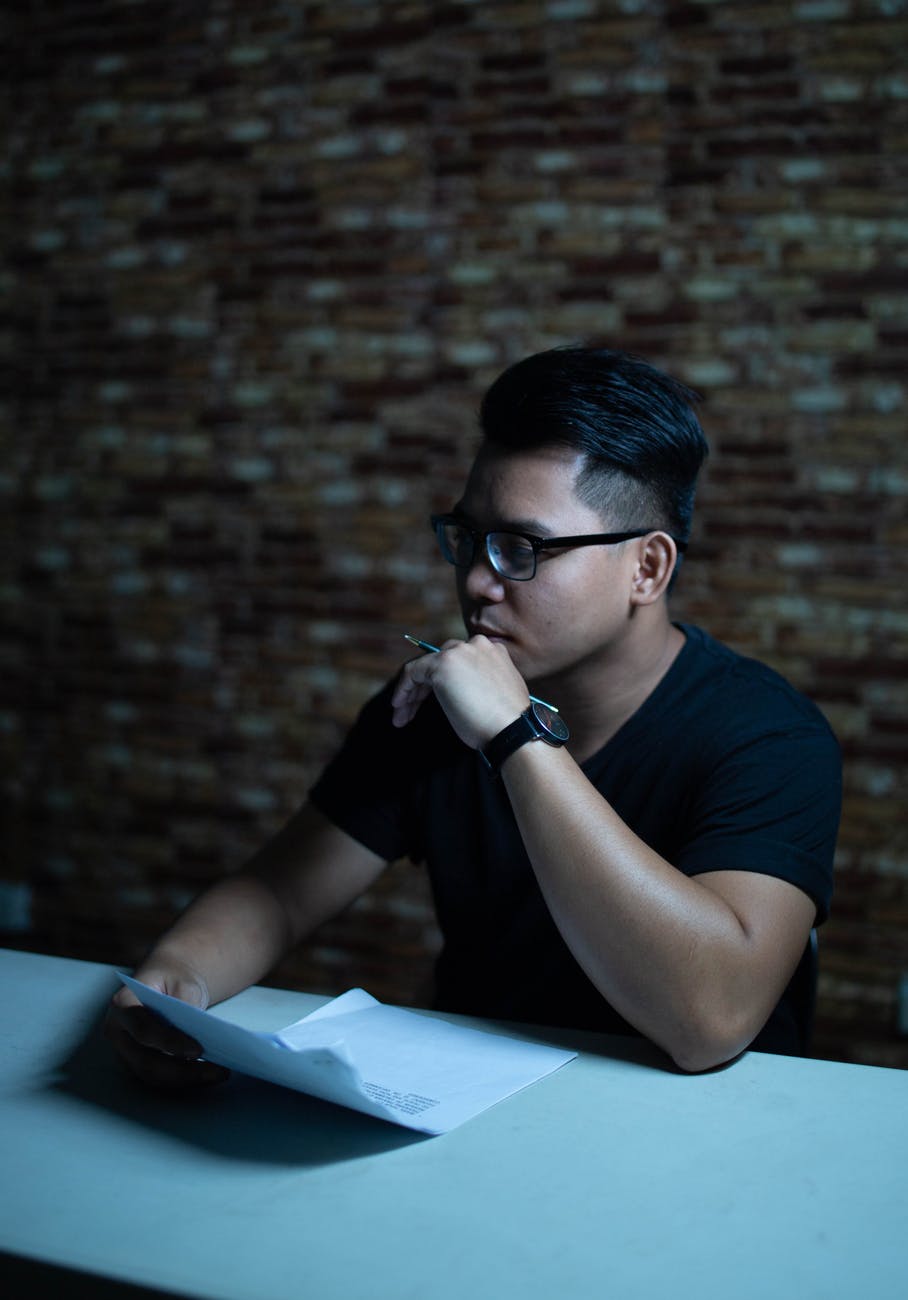 photo of man holding paper